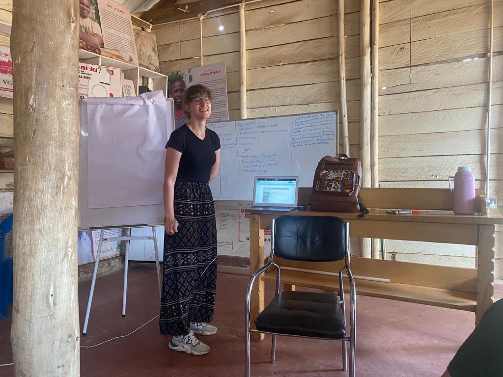 A facilitator speaking to young people in a lecture hall